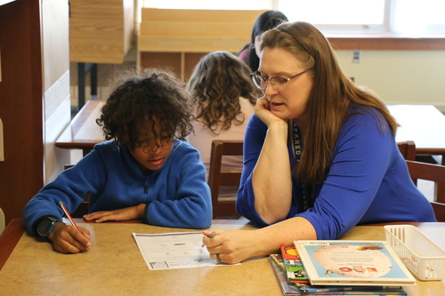 Pam Davis works with a student on homework